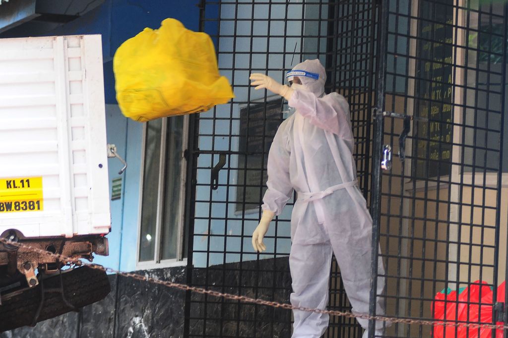 A health worker disposes of biohazard waste from a Nipah virus isolation center at a government hospital in India's southern state of Kerala.
