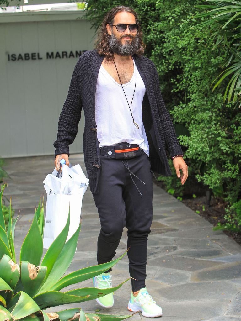Russell Brand walking out of house