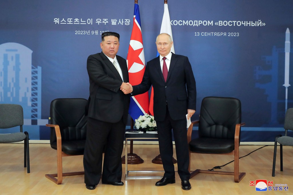 North Korean Leader Kim Jong Un shakes hands with Russian President Vladimir Putin in a staged photo.