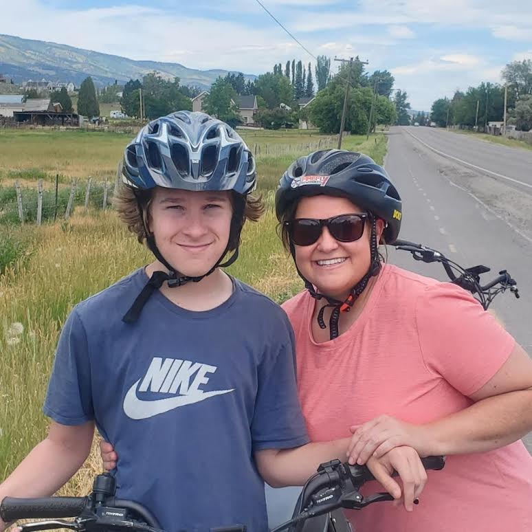 Tate Green and his mother Shonell Green riding bikes outside.