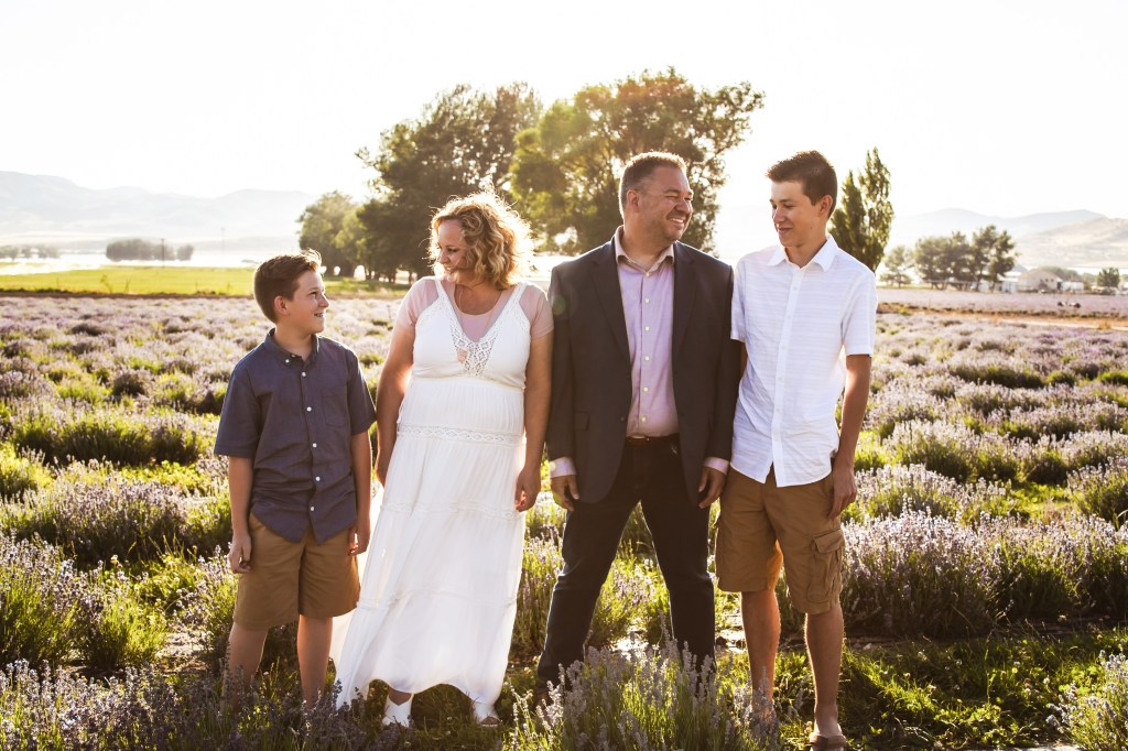 Family portrait of the Green family -- Tate, Shonell, Michael and Dylan -- in a field.