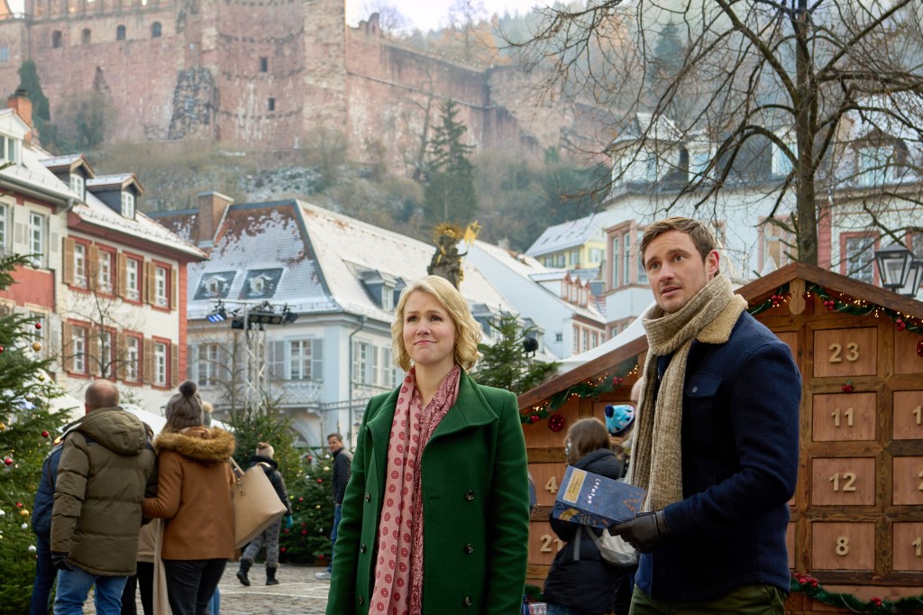 Ginna Claire Mason and Frederic Brossier in "A Heidelberg Holiday" stand at an outdoor market. 