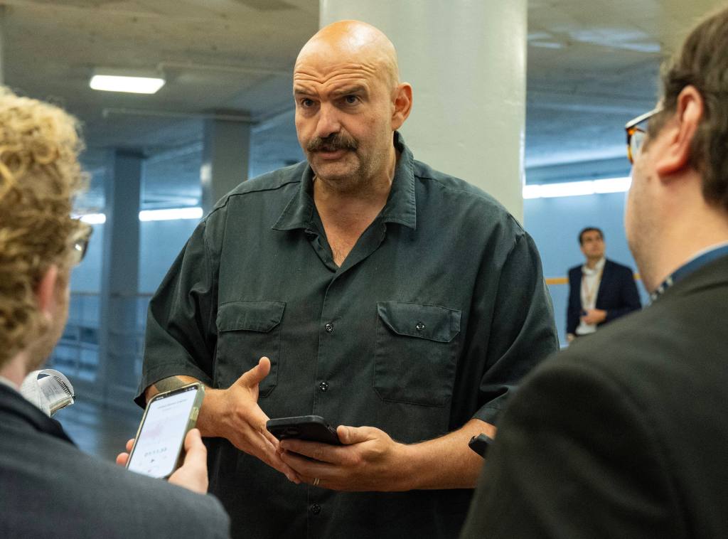 John Fetterman is seen speaking to the press