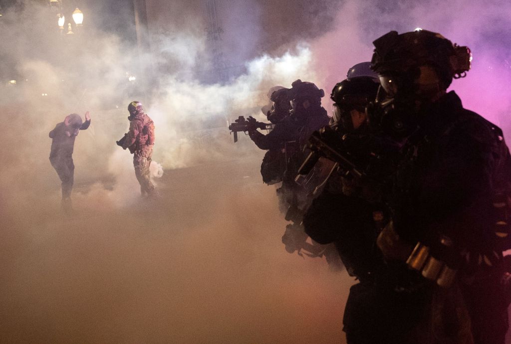 Federal agents spray tear gas and other munitions at protesters in Portland on July 30, 2020. 