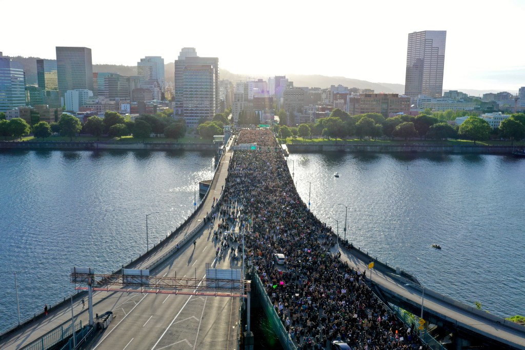 Protesters cross Morrison Bridge while rallying against the death in Minneapolis police custody of George Floyd, in Portland, Oregon, U.S. June 3, 2020. (aerial view)