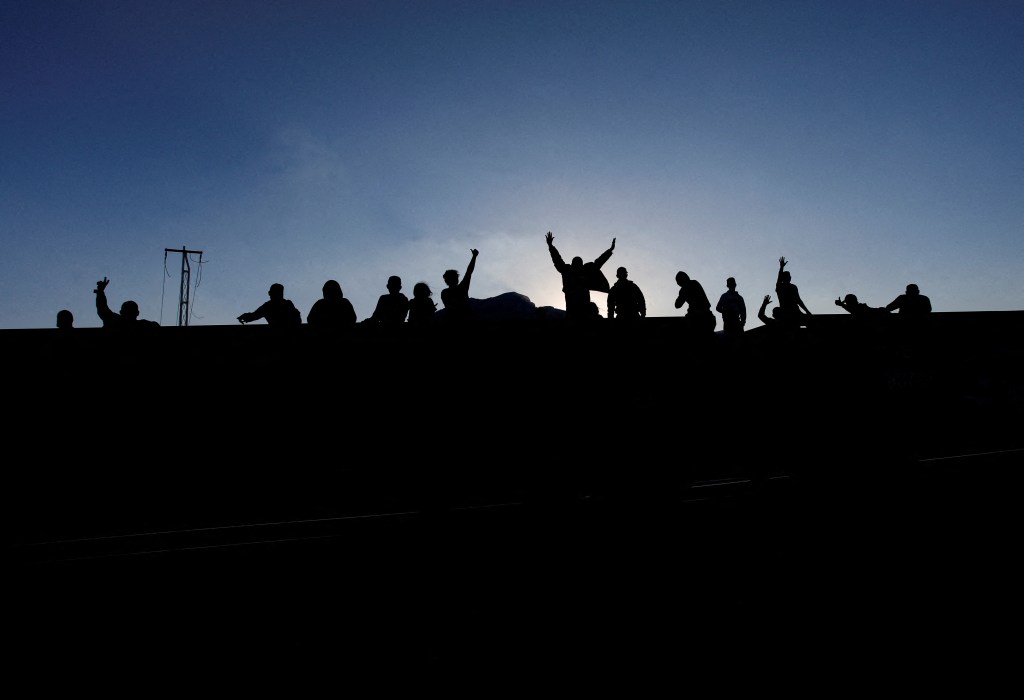 Asylum seekers heading to the U.S. travel on a train after thousands of migrants crossed into the United States in recent days, in El Carmen, Mexico September 21, 2023.