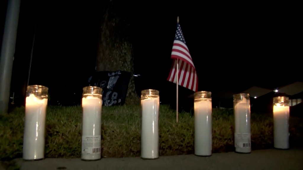 A memorial comprising six lit candles was set up in front of the high school Thursday evening.