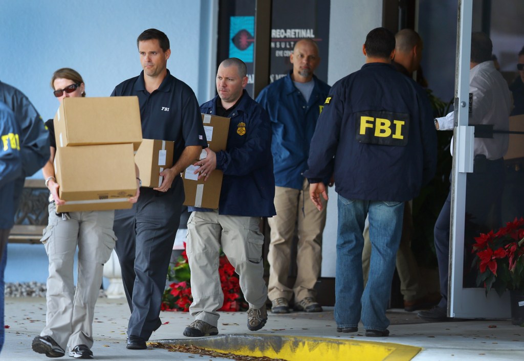 FBI agents carry out boxes as law enforcement officials investigate the medical-office complex of Dr. Salomon Melgen who has possible ties to U.S. Sen. Bob Menendez (D-NJ) on January 30, 2013 in West Palm Beach, Florida