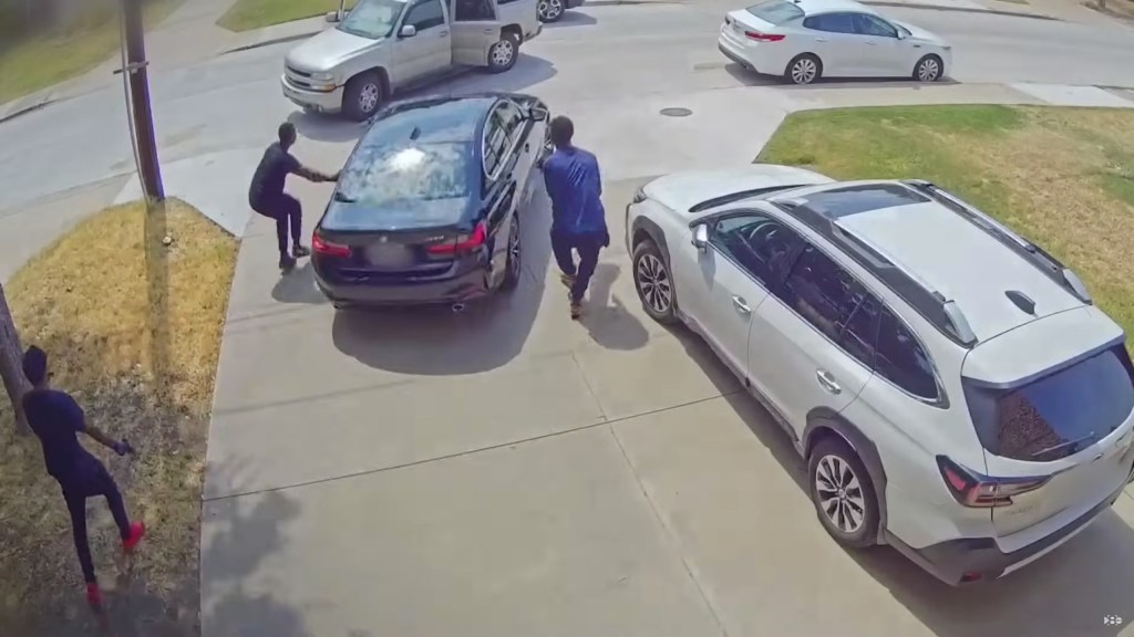 three would-be thieves are seen outside man's car.
