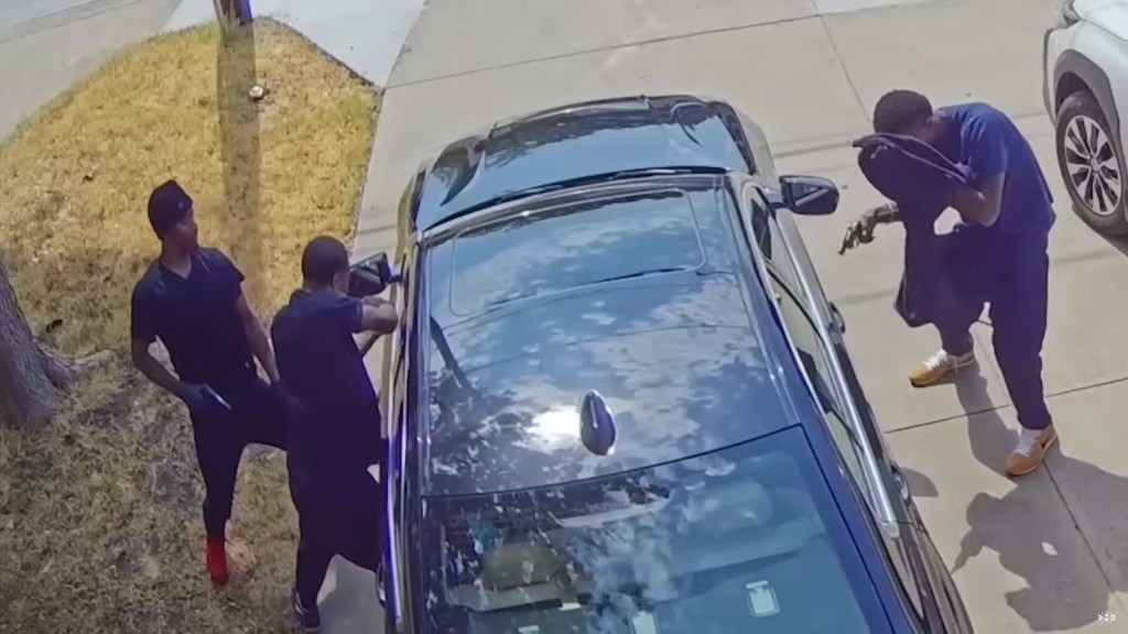 video shows armed trio surrounding man's car