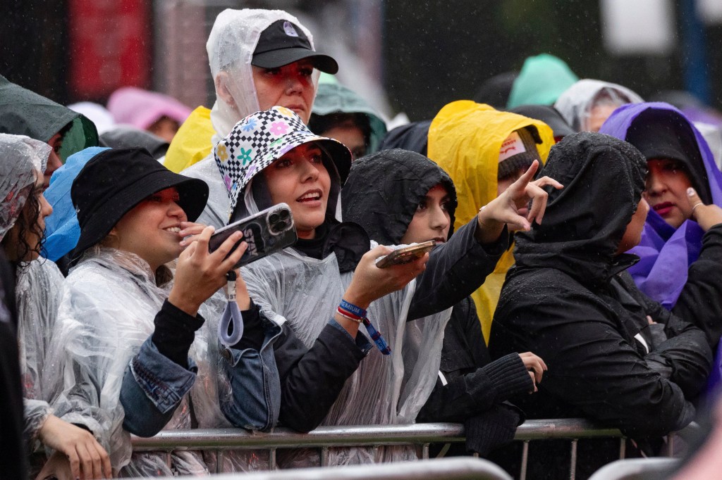 A crowd of people wearing ponchos and raincoats for the Global Citizen Festival in Central Park on September 23, 2023.