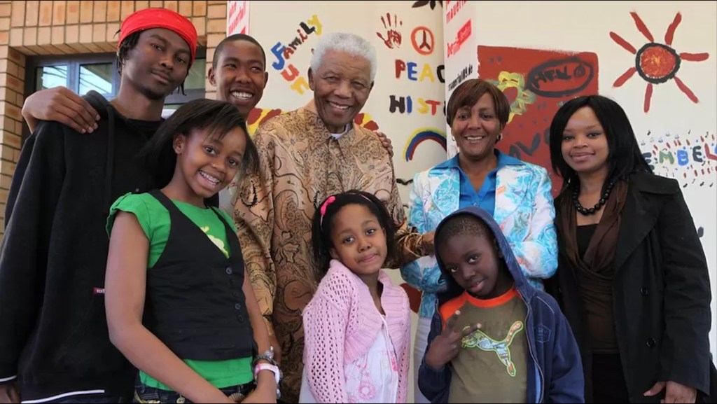 Zoleka is pictured, top right, with her grandfather and her daughter Zenani.