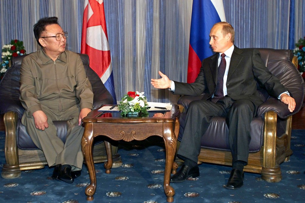 Russian President Vladimir Putin, right, gestures as he talks to North Korean then leader Kim Jong Il during their meeting in Vladivostok, Russia, on Aug. 23, 2002. 