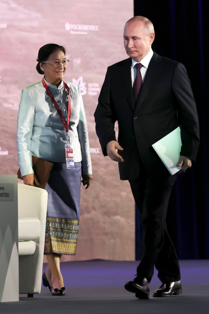 Russian President Vladimir Putin, right, and the Vice President of Laos, Pany Yathotou, left, arrive to attend a plenary session of the Eastern Economic Forum in Vladivostok, Russia, on Sep. 12, 2023. 