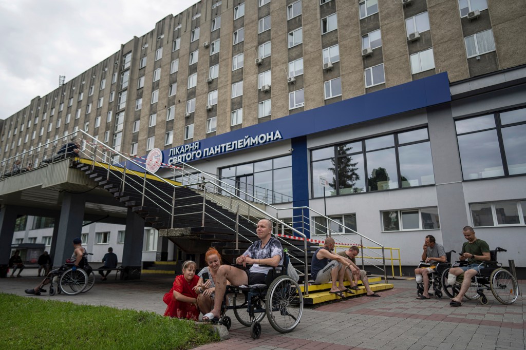 Ukrainian army veterans rest with their families and comrades outside St. Panteleimon hospital in Lviv, Ukraine. 