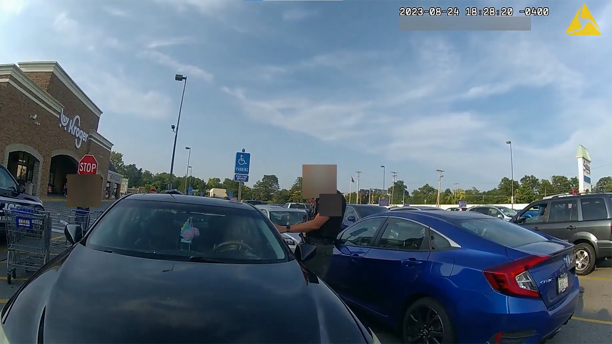 An officer standing next to the car's driver side