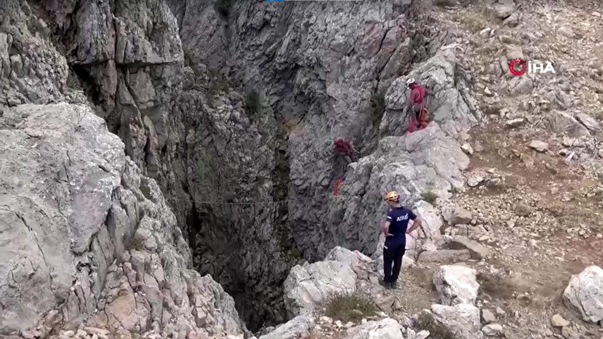 People standing near the cave