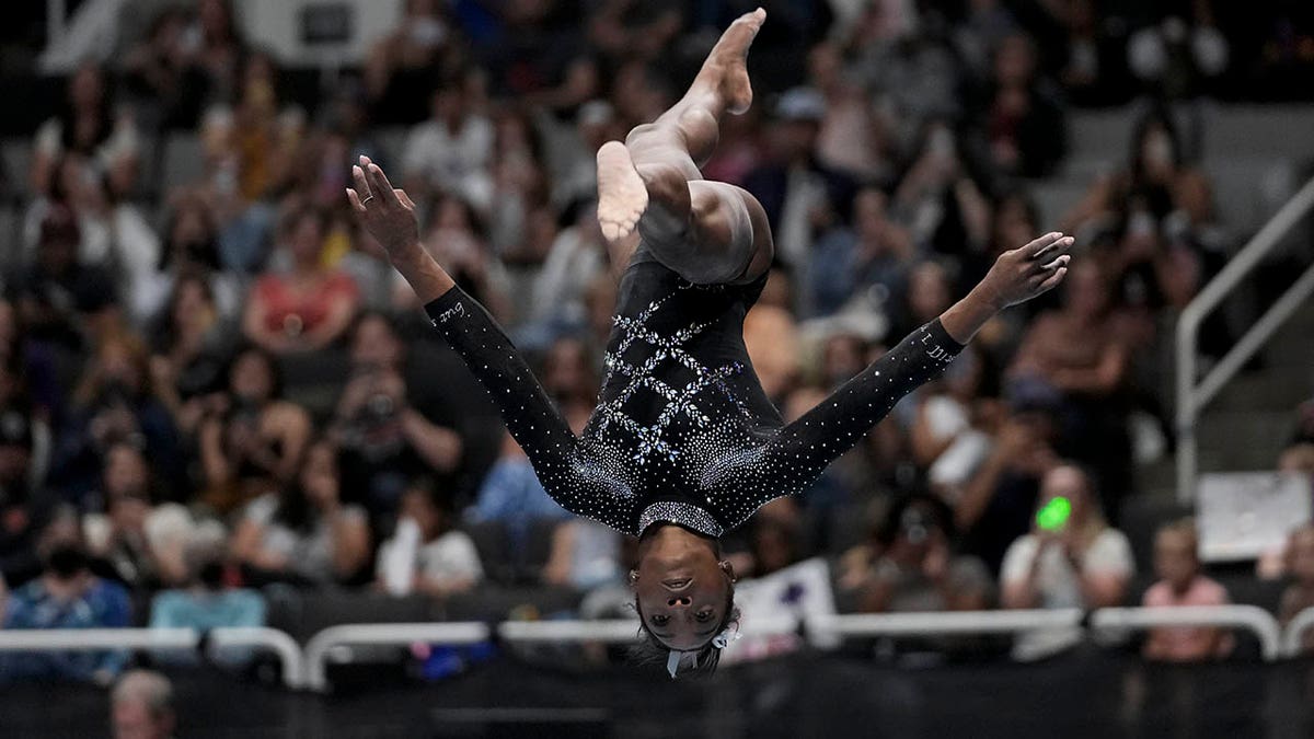 Simone Biles competes on the beam