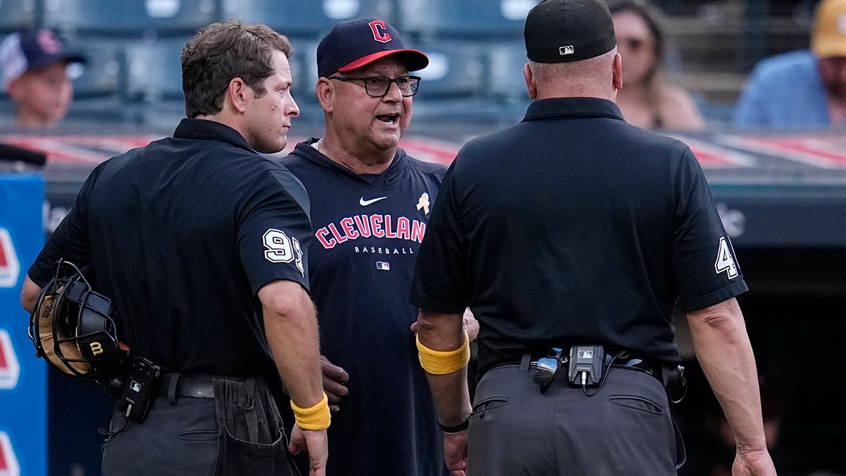 Terry Francona talks to umpires