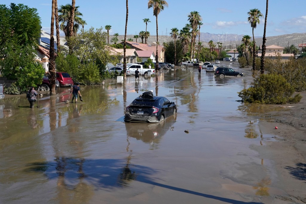 Cars are seen stuck in the mud on a street in Cathedral City, Calif.