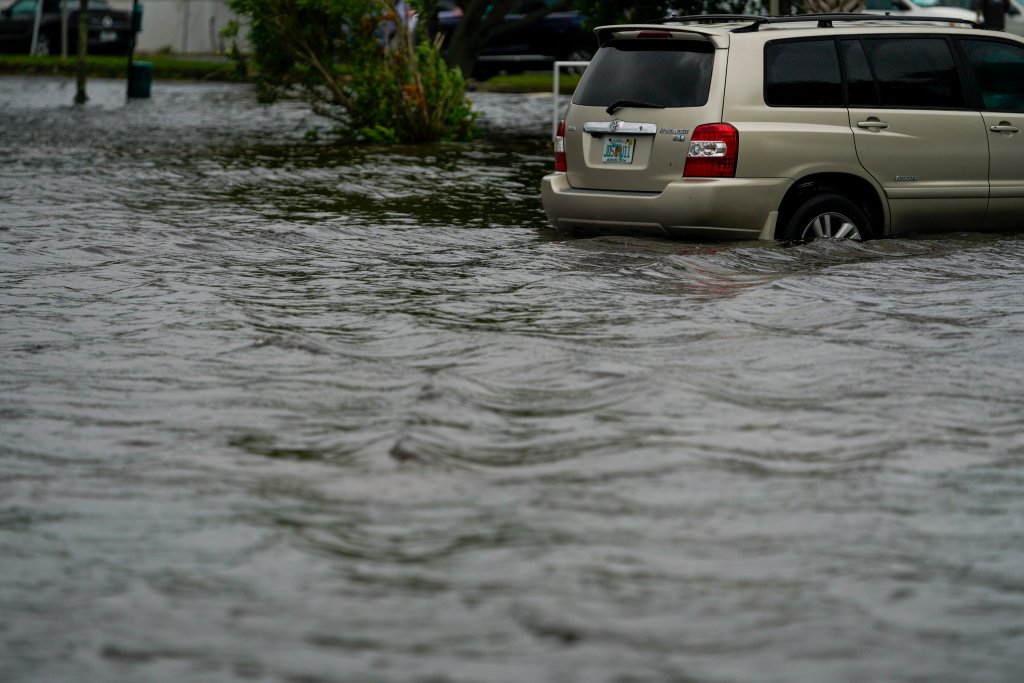 A car is parked in flood waters as Hurricane Idalia makes landfall in the Big Bend region of Florida's Gulf Coast. 