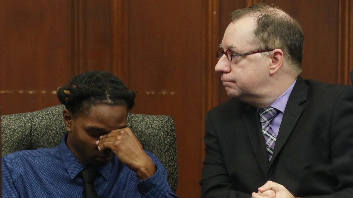 Tyler Stafford, fights back tears as he sits with his defense attorney Donald Gallick after being found guilty of assault in his trial in Summit County Common Pleas Judge Tammy O'Brien courtroom in Ethan Liming s death.