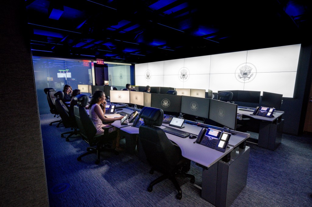 In this image provided by the White House, people sit at desks on the "watch floor," a 24-7 operations center, in the newly renovated complex of the White House Situation Room on Aug. 16, 2023, in Washington.