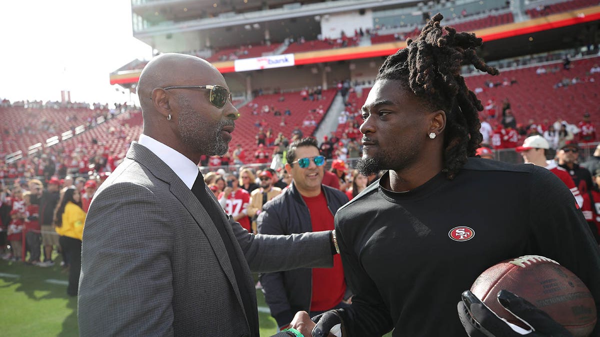 Jerry Rice greets Brandon Aiyuk