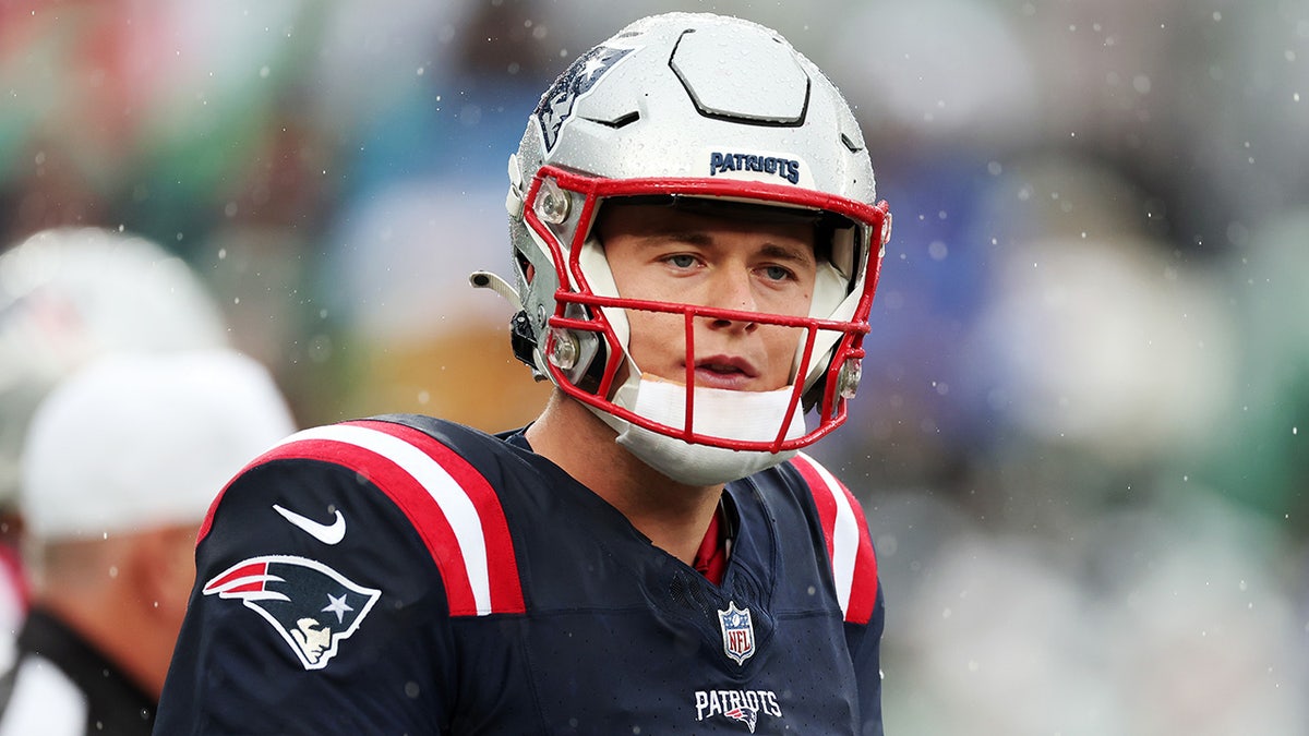 Mac Jones looks on during a Pats-Jets game