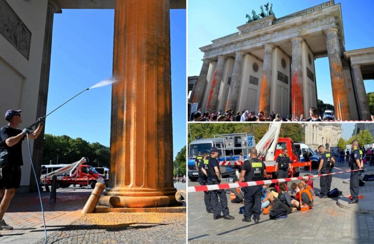 Climate activists spray Berlin’s Brandenburg Gate with orange paint