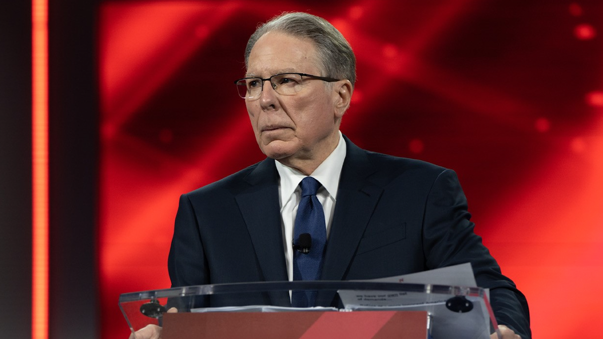 Wayne LaPierre at podium with red background behind him