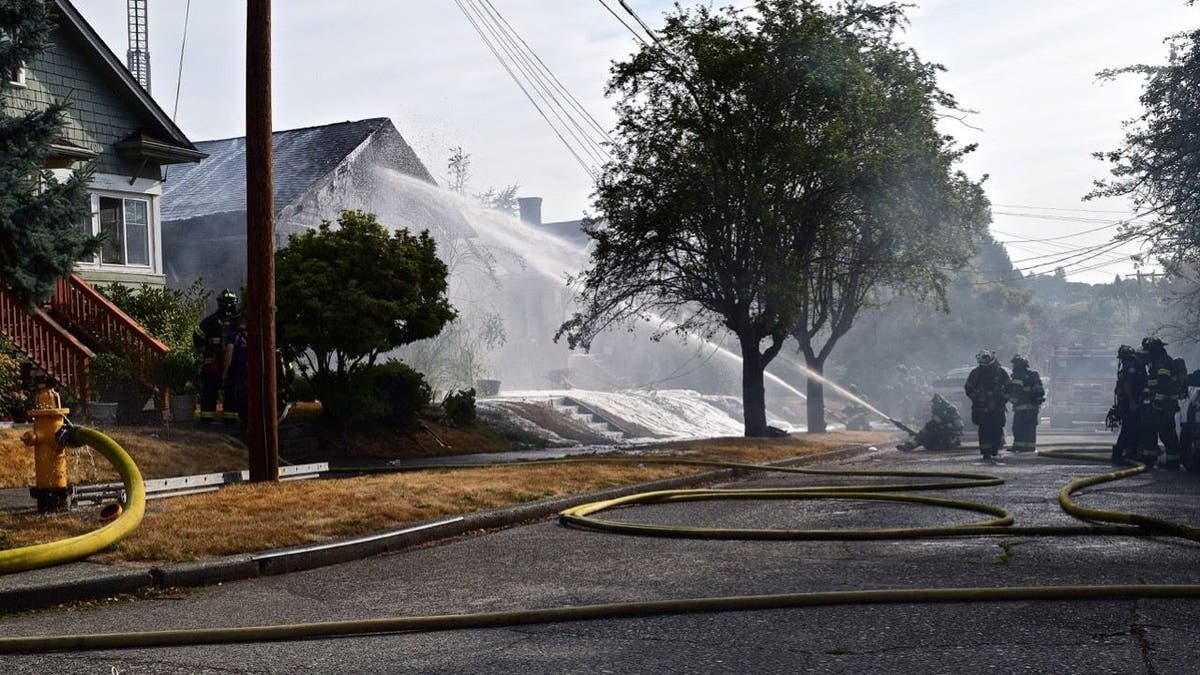 Firefighters watering down fire