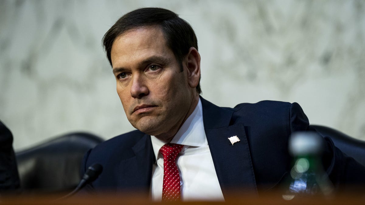 Marco Rubio in red tie, blue coat in hearing