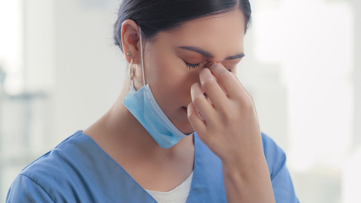 Stressed young nurse