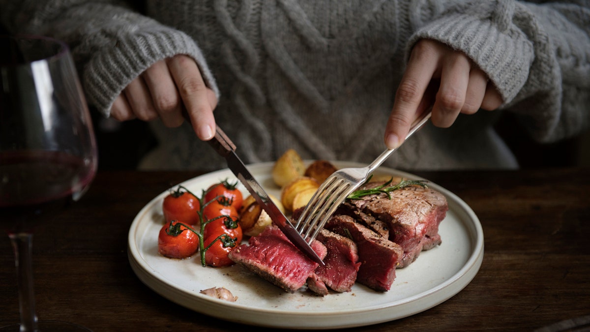 Woman eating steak