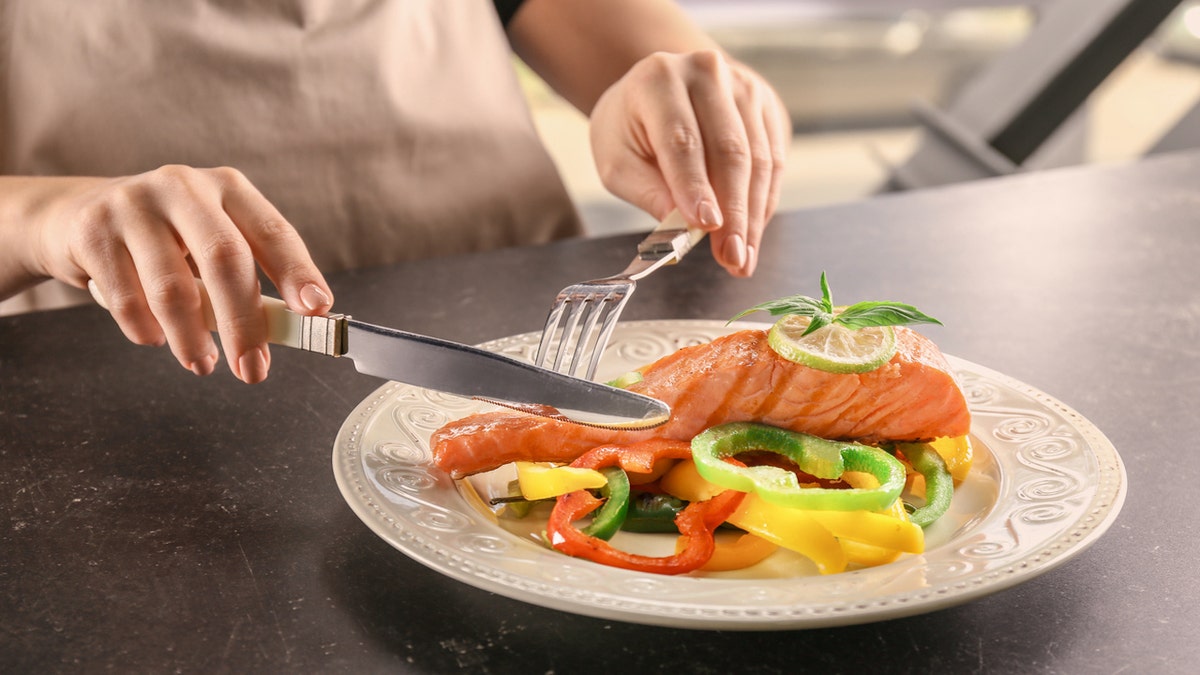 Woman eating salmon