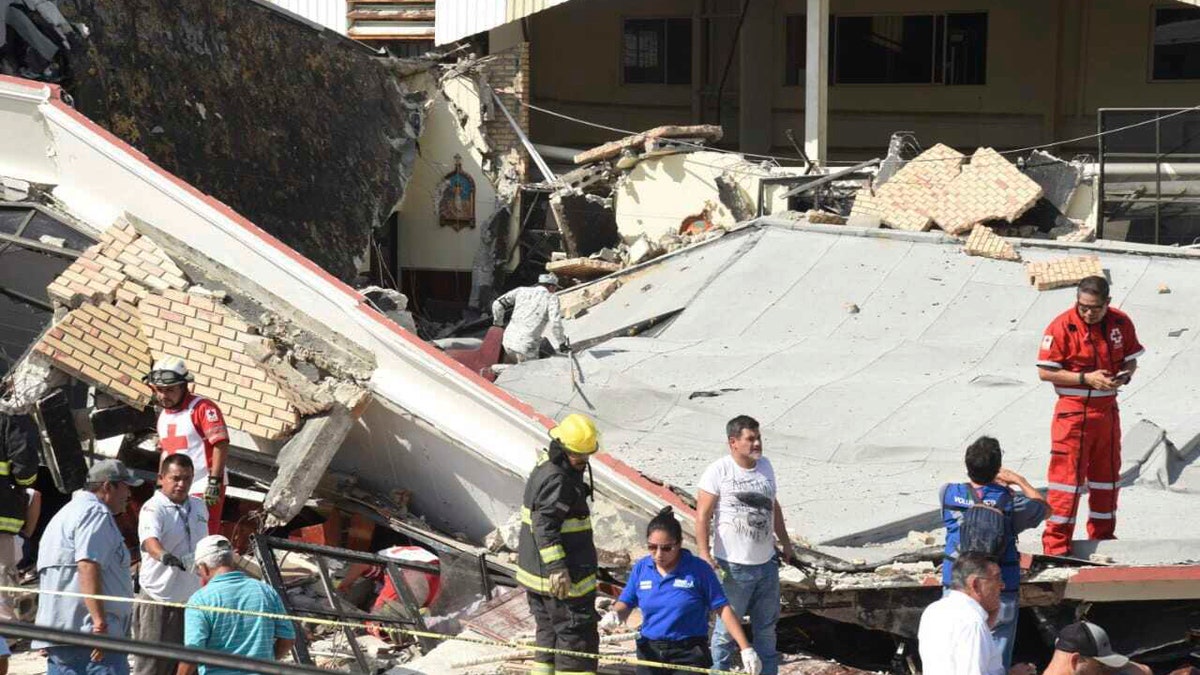 People near the collapsed church