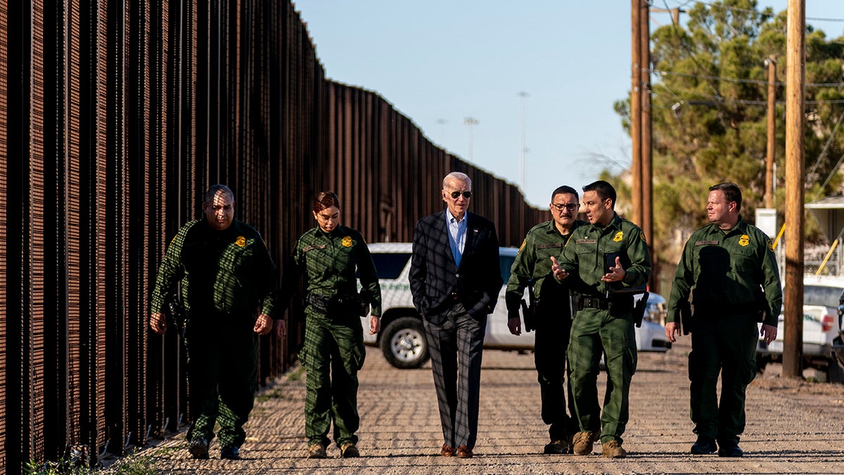 Biden walks along border wall