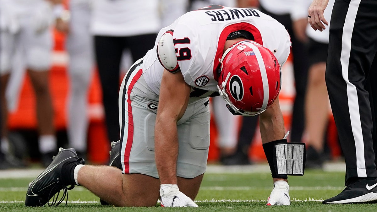 Brock Bowers down on the ground