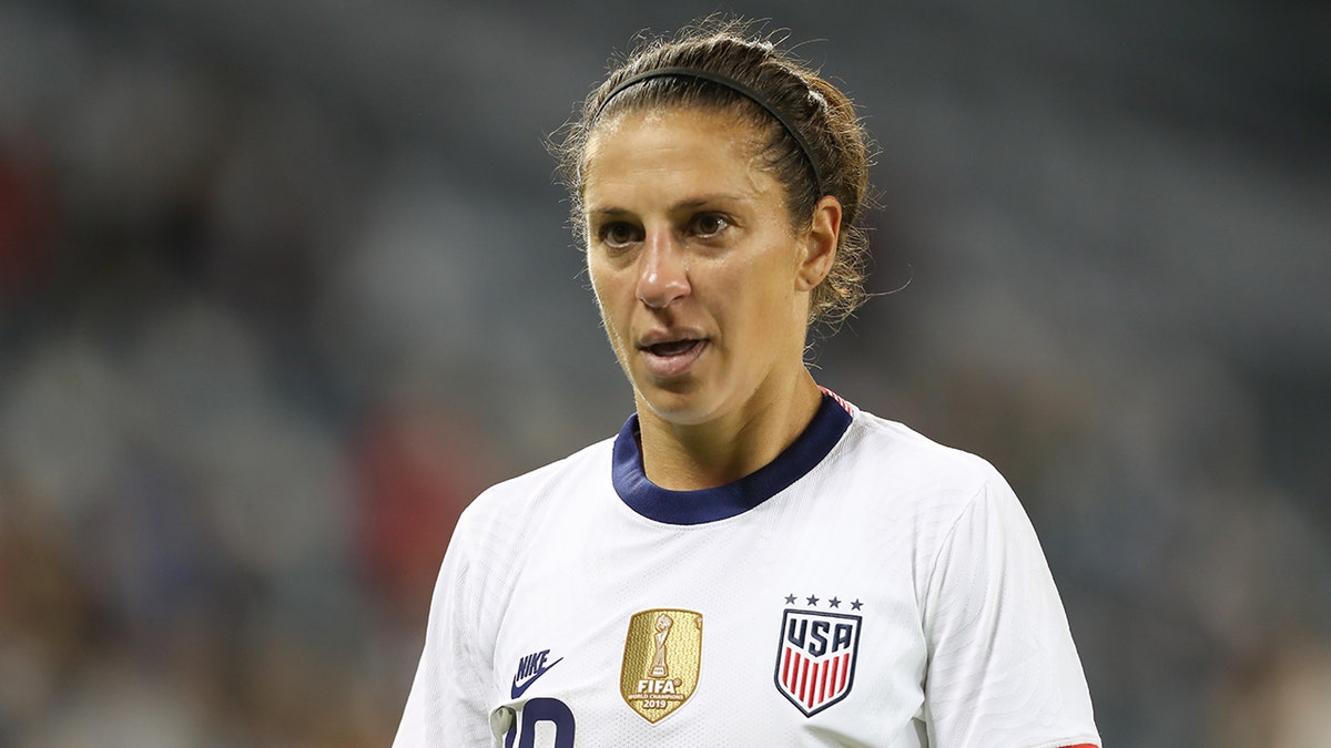 Carli Lloyd looks on field