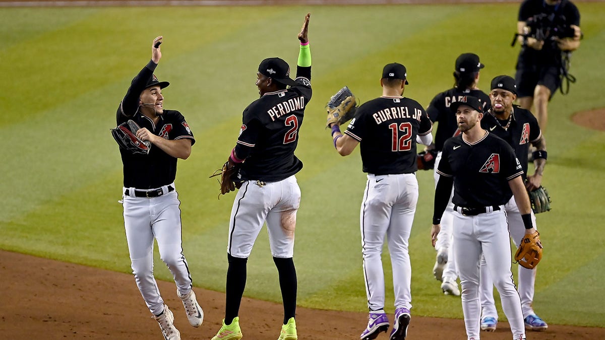 Diamondback players celebrate after NLCS game