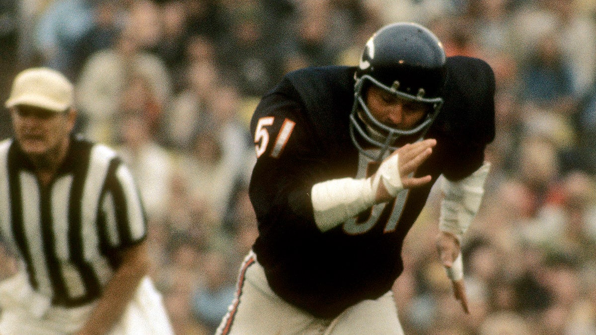 Dick Butkus runs on field