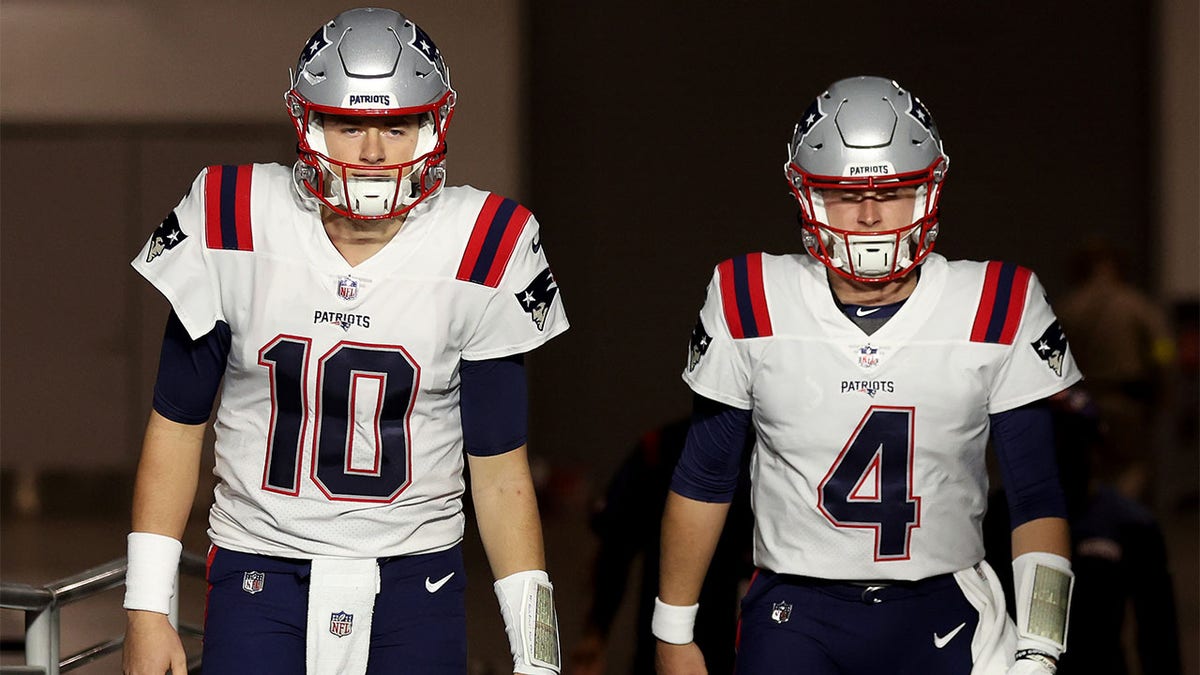 Mac Jones and Bailey Zappe walk out on the field