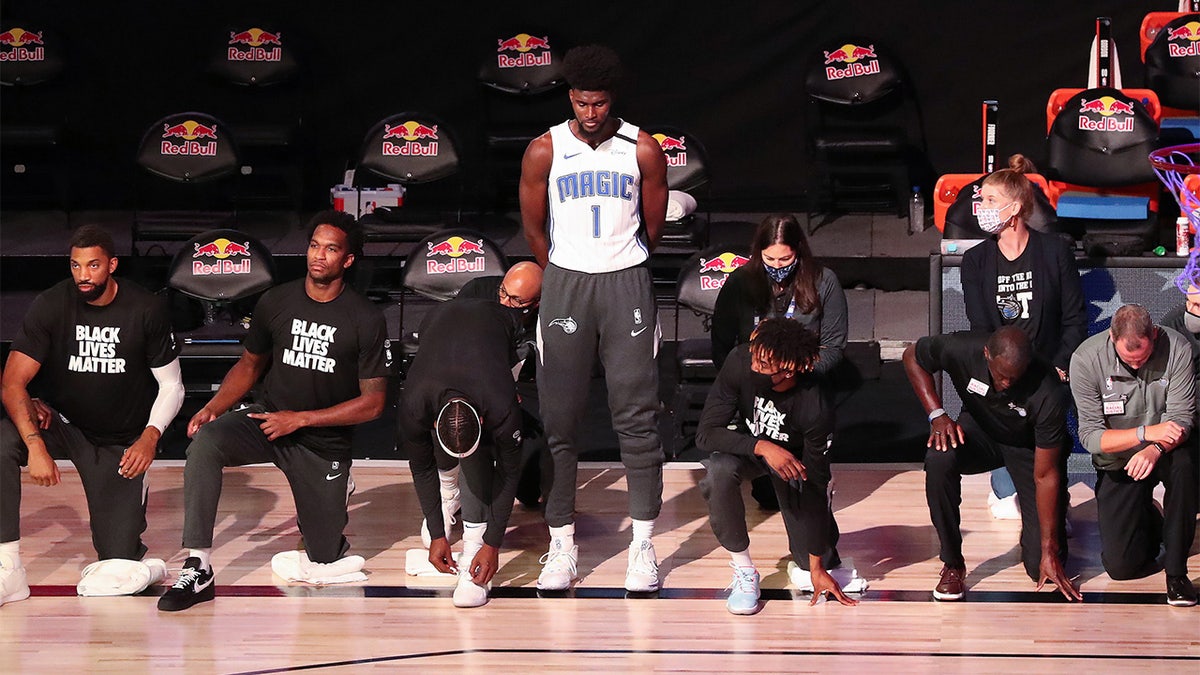 Jonathan Isaac stands during the national anthem