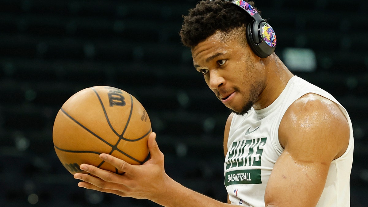 Giannis Antetokounmpo warms up