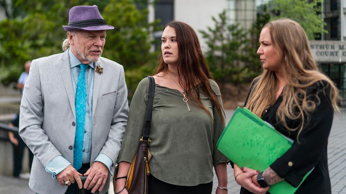 John Ray walks out of court with victims family