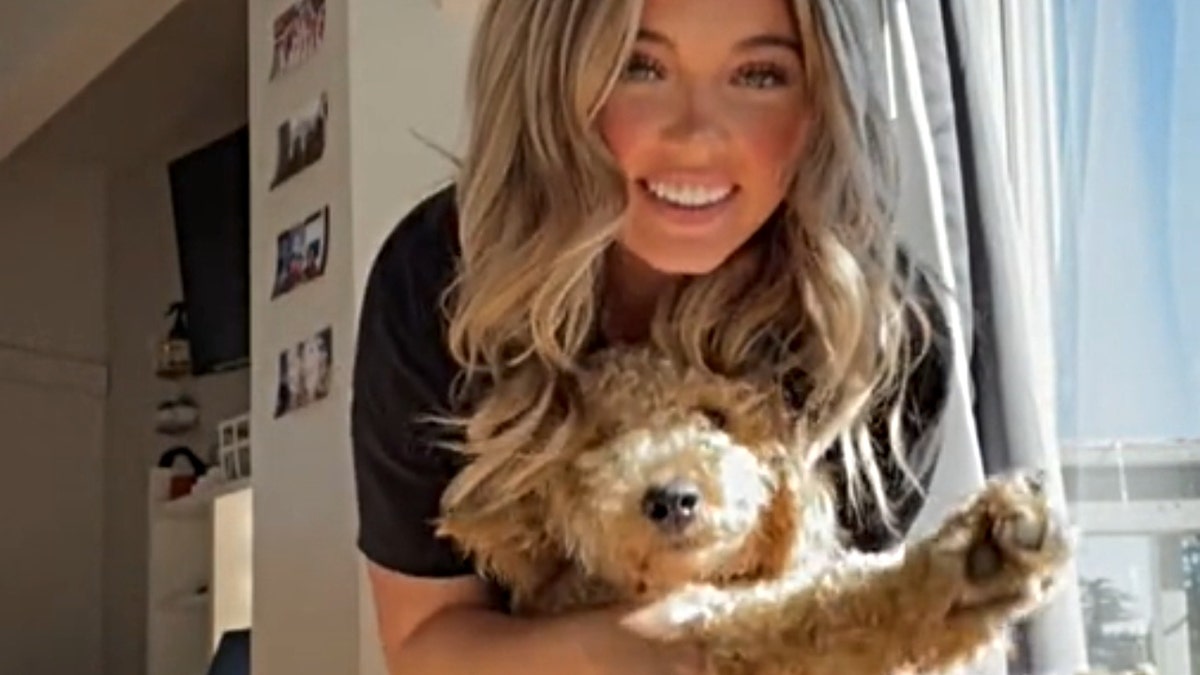 Kaylee Goncalves dancing with her dog, Murphy