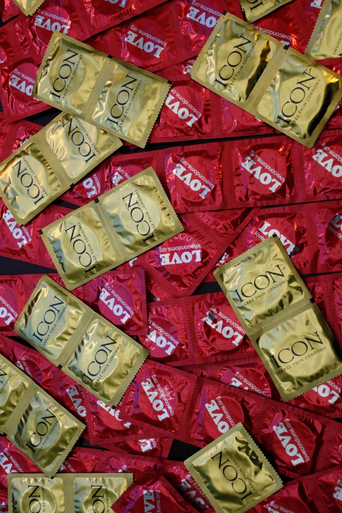 Red and gold wrapped condoms in a pile. 