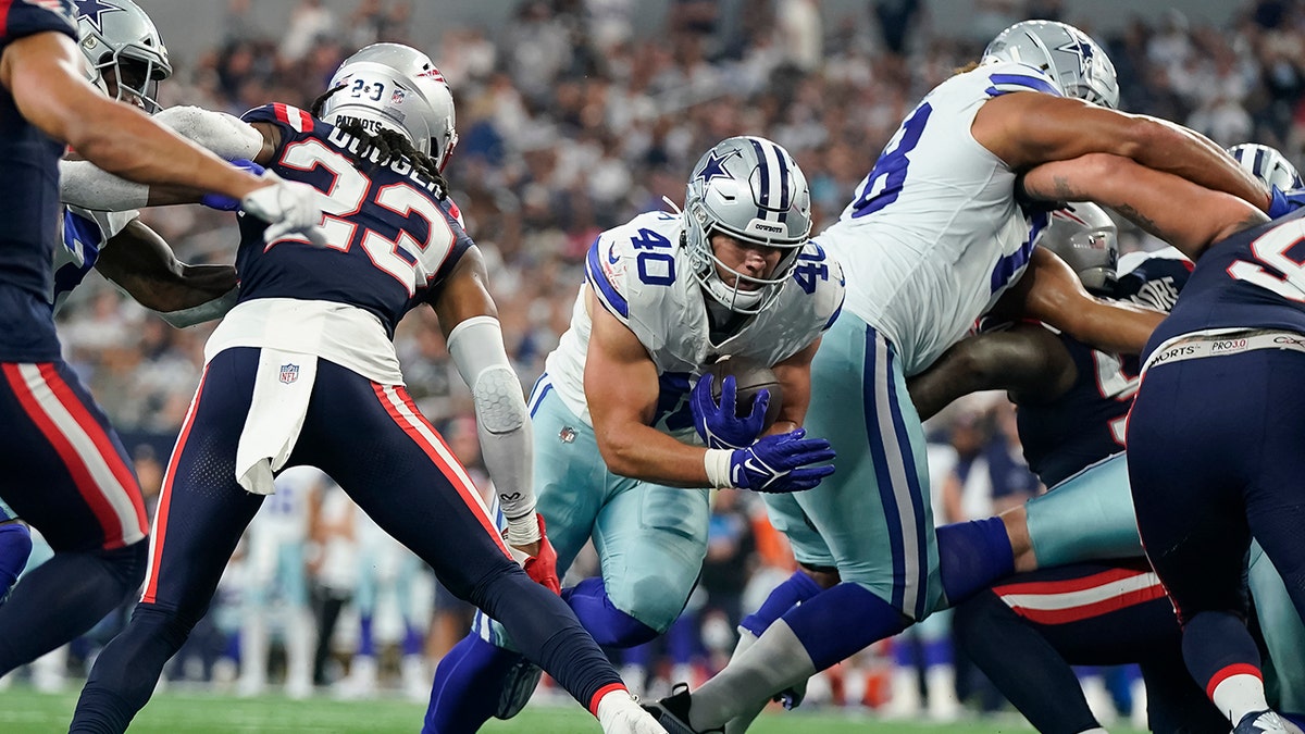 Dallas Cowboys player runs with the football