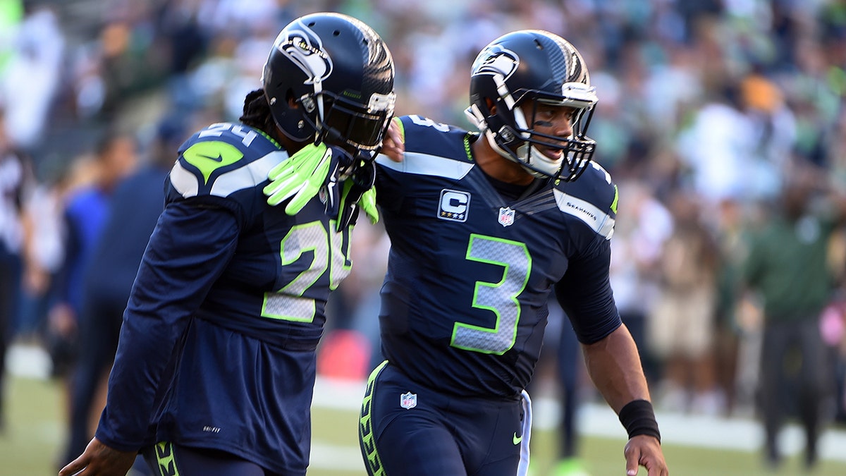  Russell Wilson greets Marshawn Lynch